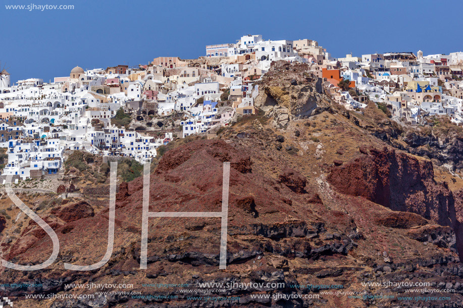 Red rocks and Oia town, Santorini island, Cyclades, Greece