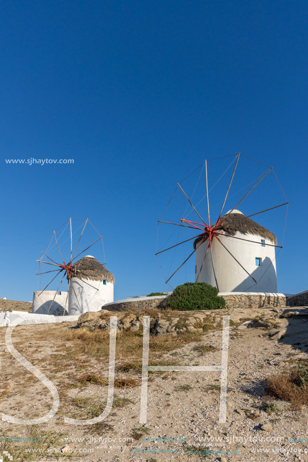 White windmill and Stone wall on the island of Mykonos, Cyclades, Greece