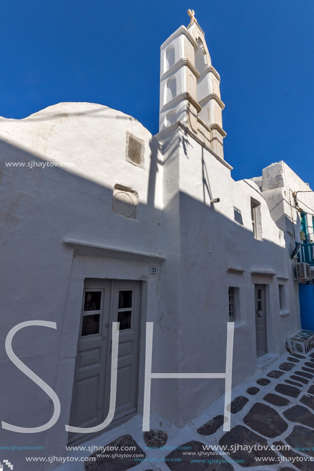 White orthodox church and small bell tower in Mykonos, Cyclades Islands, Greece