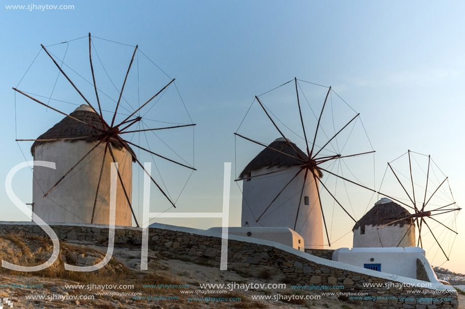 Sunset of White windmills and Aegean sea on the island of Mykonos, Cyclades, Greece