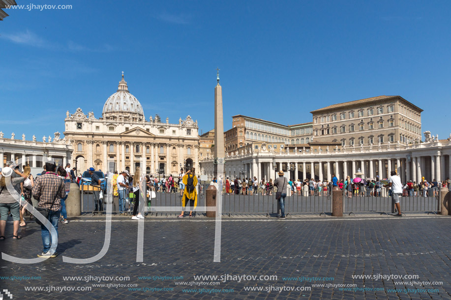 ROME, ITALY - JUNE 23, 2017: Tourists visit Saint Peter"s Square and St. Peter"s Basilica in Rome, Vatican, Italy