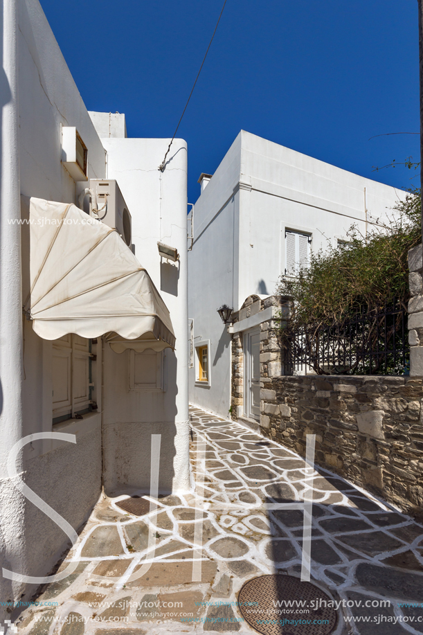 PAROS, GREECE - MAY 3, 2013: Typical street with white houses in town of Parakia, Paros island, Cyclades, Greece