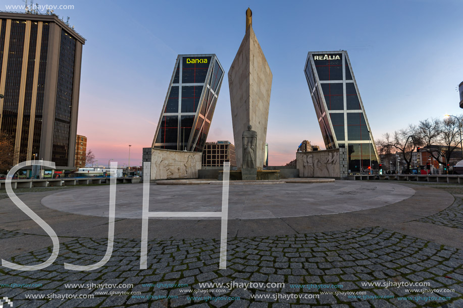 MADRID, SPAIN - JANUARY 23, 2018:  Sunrise view of Gate of Europe (KIO Towers) and Monument to Jose Calvo Sotelo at Paseo de la Castellana street in City of Madrid, Spain