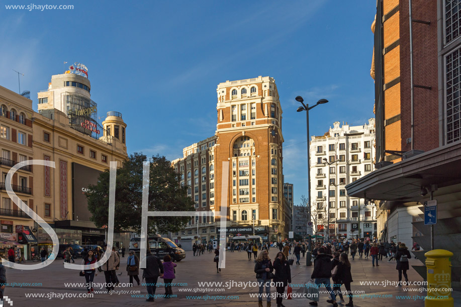 MADRID, SPAIN - JANUARY 23, 2018: Sunset view of walking people at Callao Square (Plaza del Callao) in City of Madrid, Spain