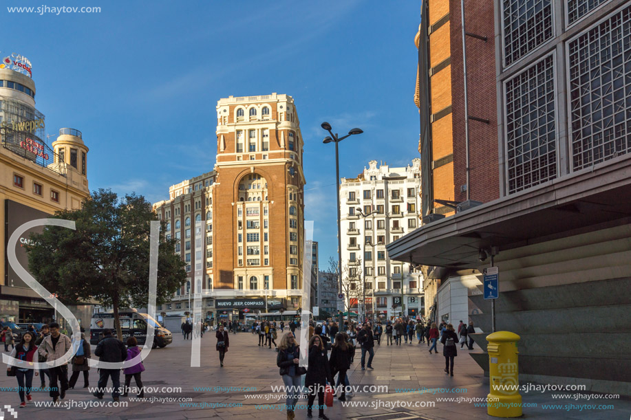 MADRID, SPAIN - JANUARY 23, 2018: Sunset view of walking people at Callao Square (Plaza del Callao) in City of Madrid, Spain