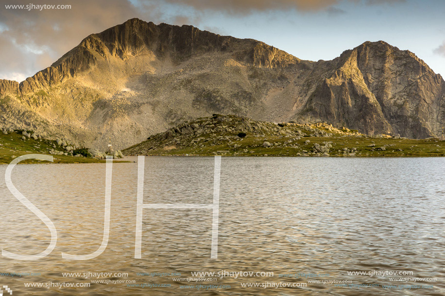 Yellow Sunset over Tevno Lake and Kamenitsa peak, Pirin Mountain, Bulgaria