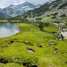 Banderishki Chukar peak and reflection in Muratovo lake Before storm, Pirin Mountain, Bulgaria