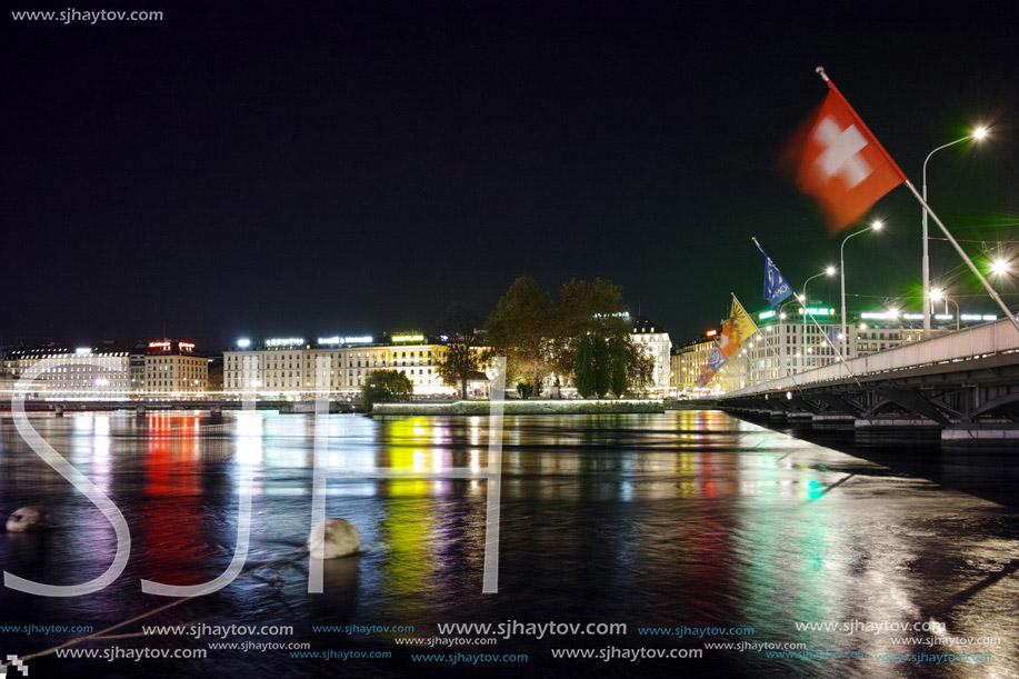 Night photo of City of Geneva and bridge over  Rhone River, Switzerland