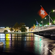 Night photo of City of Geneva and bridge over  Rhone River, Switzerland