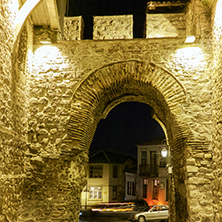 Night photo of Cobblestone street under ancient fortress entrance of old town of city of Plovdiv, Bulgaria