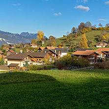 Green meadows and typical Switzerland village near town of interlaken, canton of Bern, Switzerland