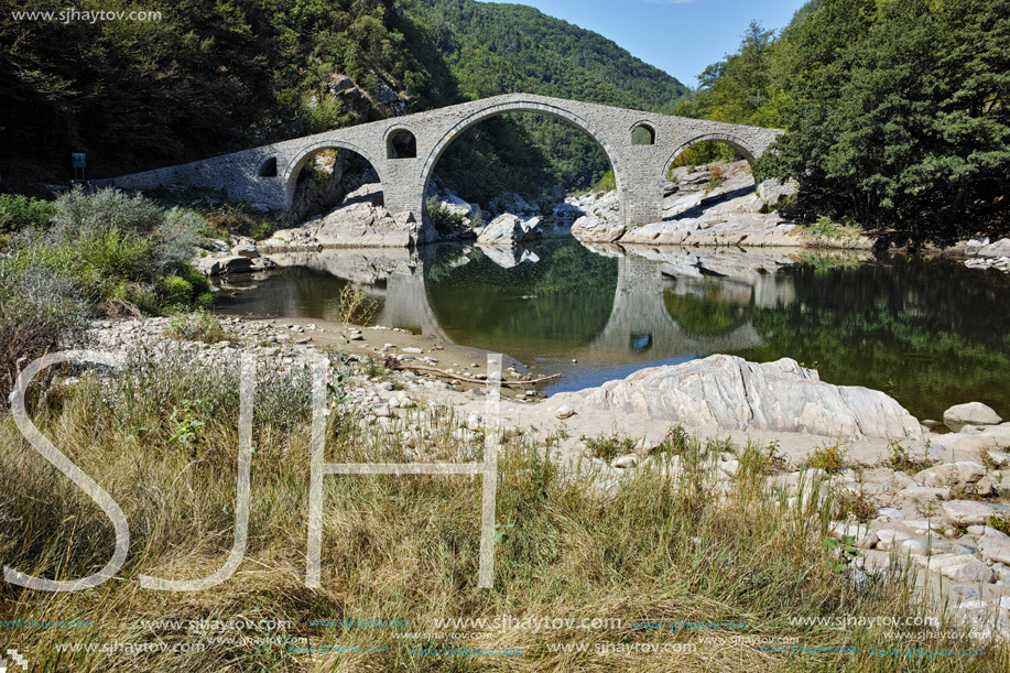 Reflection of Devil"s Bridge in Arda river and Rhodopes mountain, Kardzhali Region, Bulga