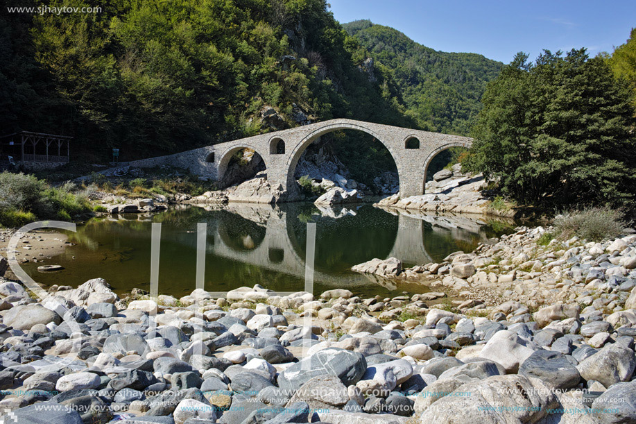 Reflection of Devil"s Bridge and Rhodopes mountain in Arda river, Kardzhali Region, Bulgaria