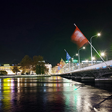 Amazing night photo of City of Geneva and Reflection of bridge in Rhone River, Switzerland
