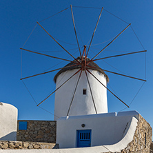 White windmill and Stone wall on the island of Mykonos, Cyclades, Greece