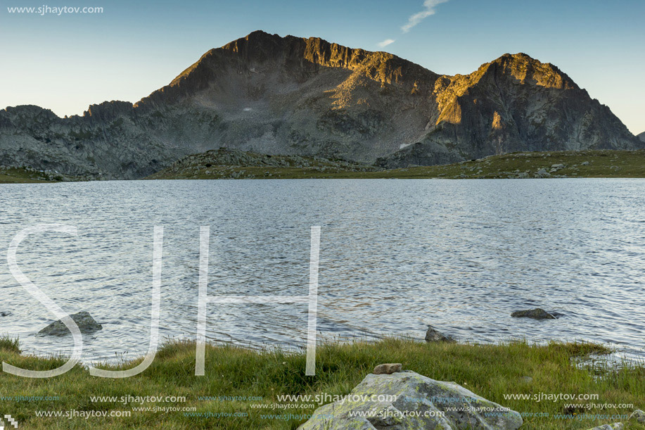 The last rays of the sun over Tevno Lake and Kamenitsa peak, Pirin Mountain, Bulgaria