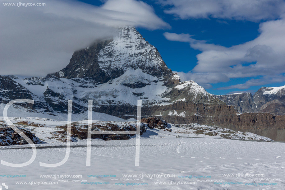 Amazing panorama of matterhorn peak covered with clods, Alps, Switzerland