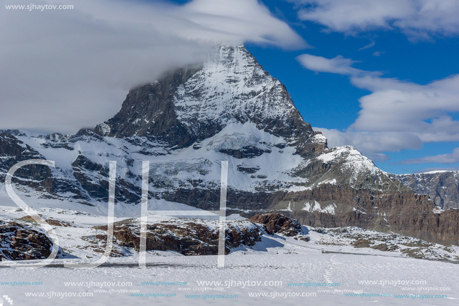 Amazing landscape of matterhorn peak covered with clods, Alps, Switzerland