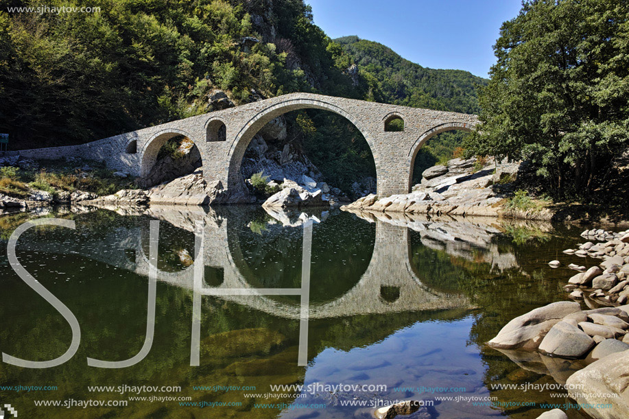Reflection of The Devil"s Bridge and Rhodopes mountain in Arda river, Kardzhali Region, Bulgaria