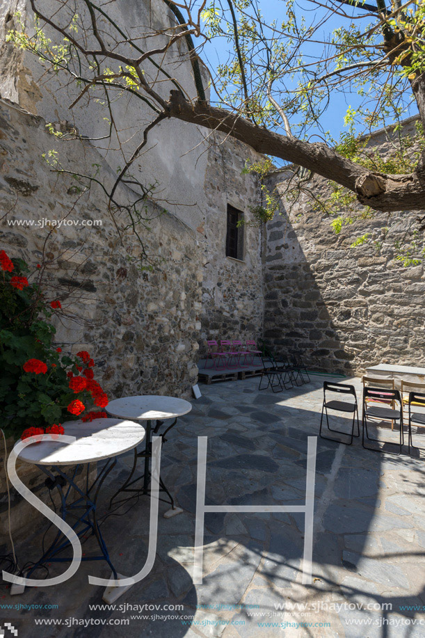 Castle wall of the fortress and red flowers in Chora town, Naxos Island, Cyclades, Greece