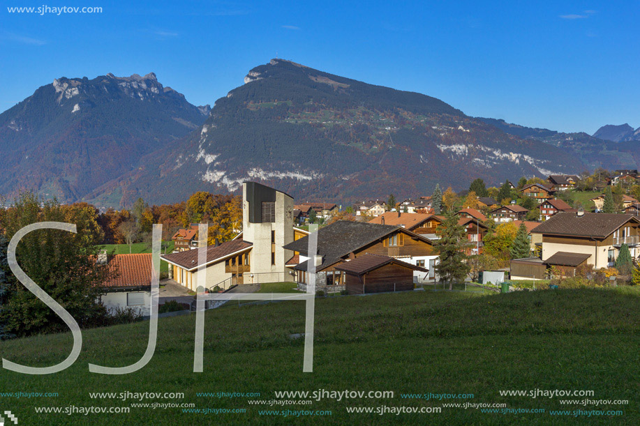 Green meadows and typical Switzerland village near town of interlaken, canton of Bern, Switzerland