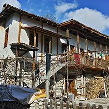 Old house with wooden porch in village of Rozhen, Blagoevgrad region, Bulgaria