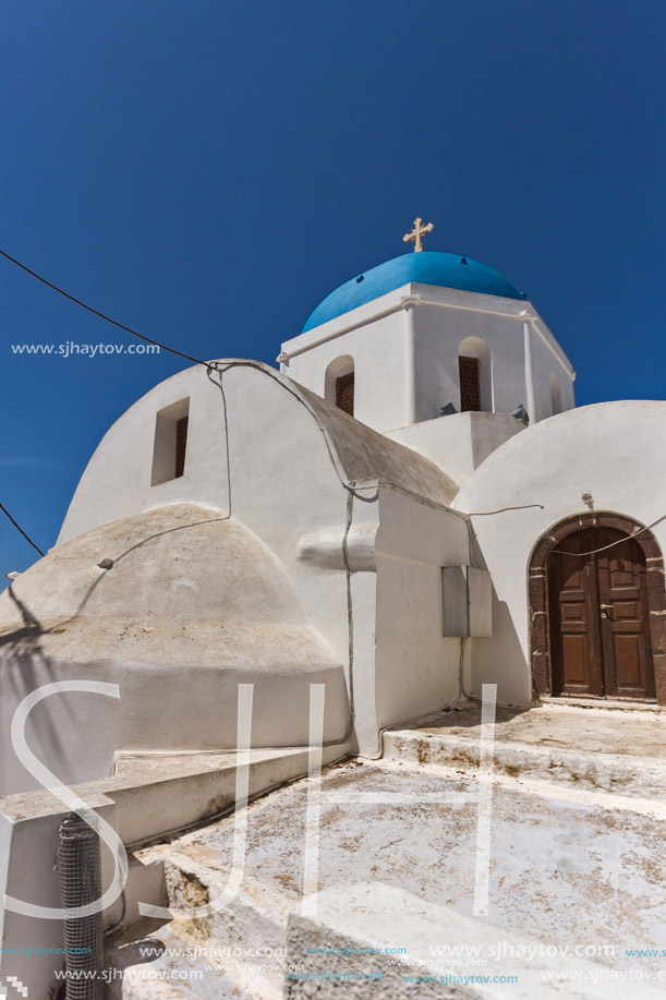 White Orthodox church with blue roof in Santorini island, Thira, Cyclades, Greece