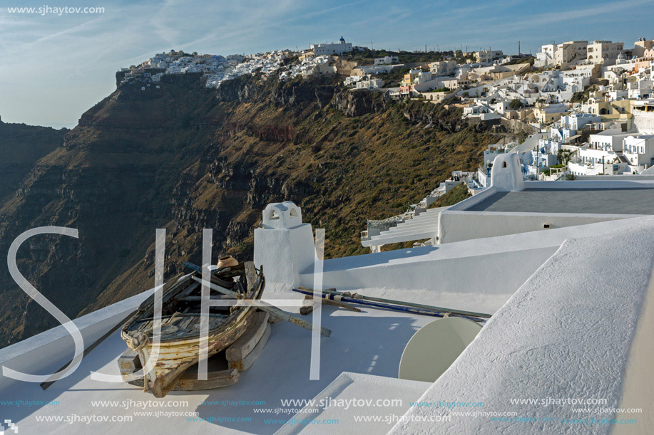 Old boat and Panoramic view to towns of Imerovigli and Firostefani, Thira, Cyclades, Greece