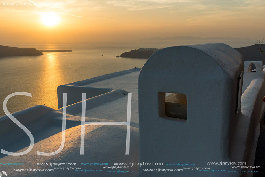 White roof and Amazing sunset in town of Imerovigli, Santorini island, Thira, Cyclades, Greece