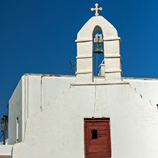 White orthodox church and small bell tower in Mykonos, Cyclades Islands, Greece