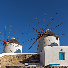 White windmill and Stone wall on the island of Mykonos, Cyclades, Greece