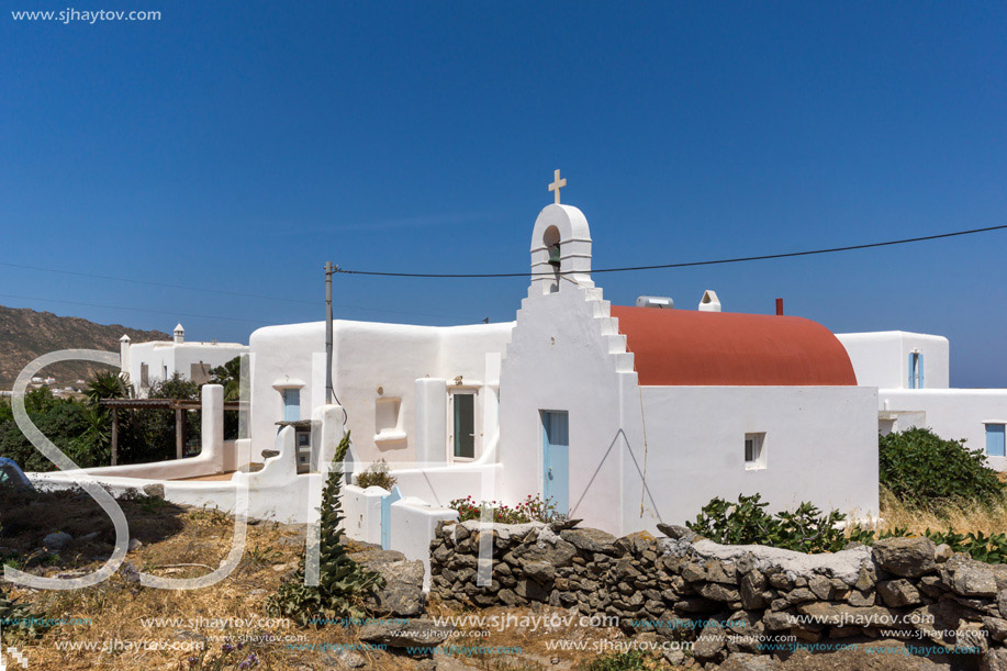 White church with red roof in town of Ano Mera, Mykonos island, Cyclades, Greece