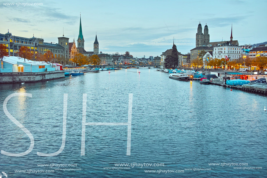 Night photo of city of Zurich and reflection in Limmat River, Switzerland