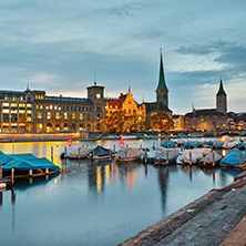 Night panoramic photo of city of Zurich and reflection in Limmat River, Switzerland