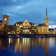 Night photo of Fraumunster Church and reflection in Limmat River, city of Zurich, Switzerland