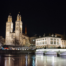 Reflection of lights of Grossmunster church in Limmat River, city of Zurich, Switzerland
