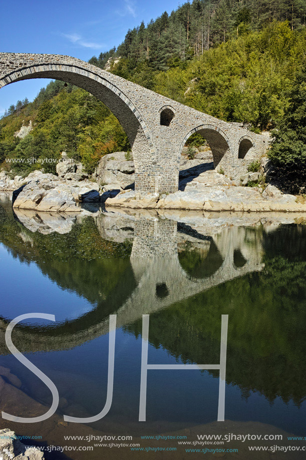 Reflection of Devil Bridge in Arda river and Rhodopes mountain, Kardzhali Region, Bulgaria