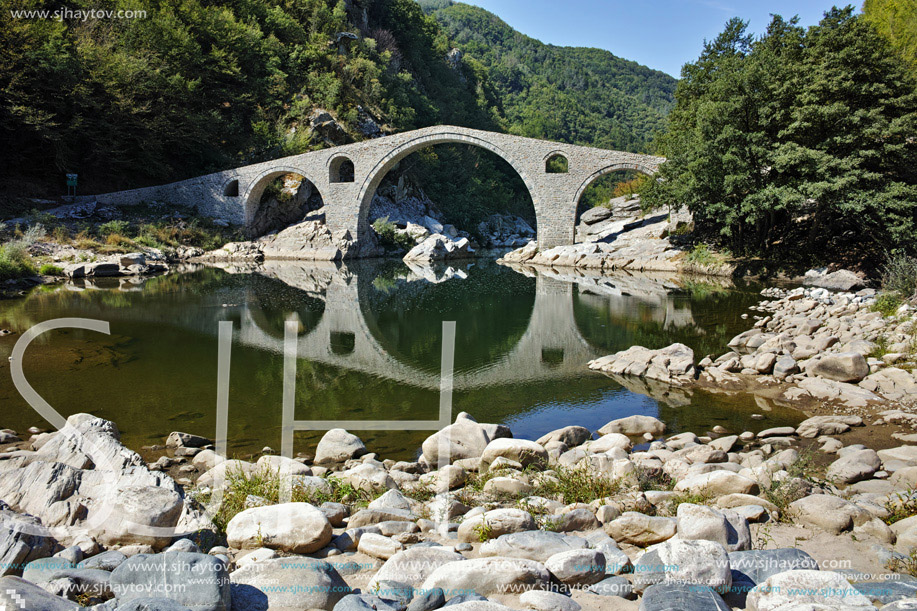 Reflection of Devil Bridge and Rhodopes mountain in Arda river, Kardzhali Region, Bulgaria