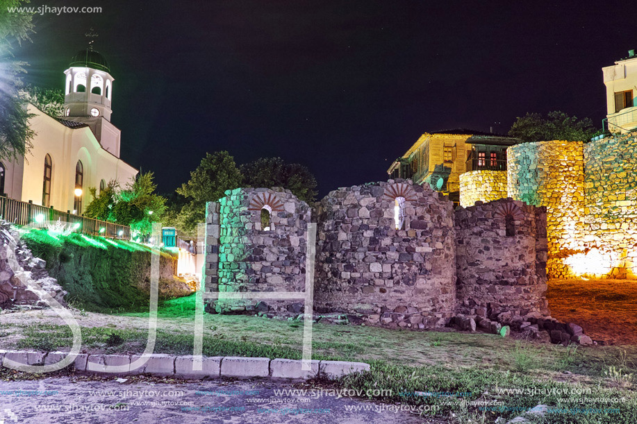 Night photo of Saints Cyril and Methodius church and reconstructed gate part of Sozopol ancient fortifications, Bulgaria