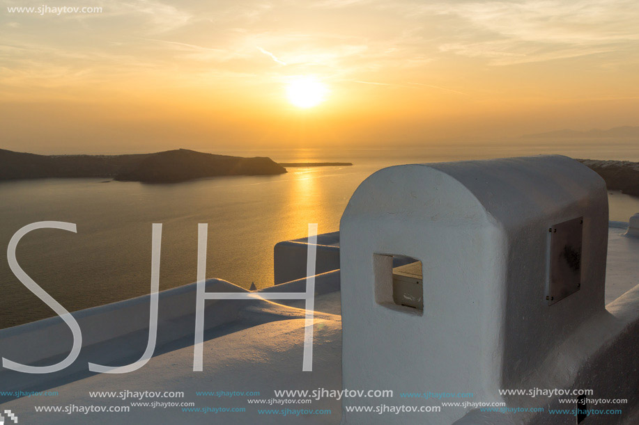 White roof and Amazing sunset in town of Imerovigli, Santorini island, Thira, Cyclades, Greece