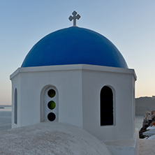 Church with blue roof in town of Oia and panorama to Santorini island, Thira, Cyclades, Greece