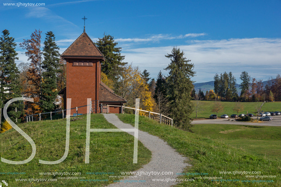 Old church and autumn trees near mount Rigi, Alps, Switzerland