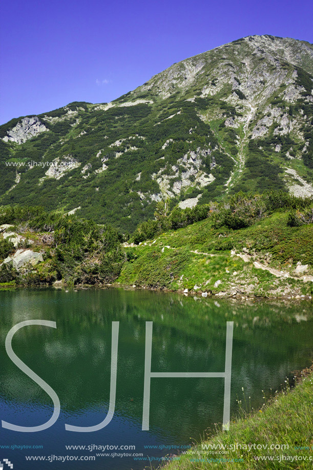 Reflection of Hvoynati peak in Okoto lake, Pirin Mountain, Bulgaria