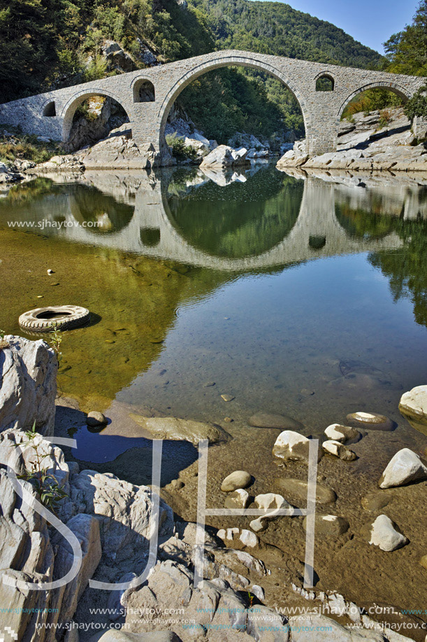 Reflection of Devil"s Bridge in Arda river and Rhodopes mountain, Kardzhali Region, Bulgaria