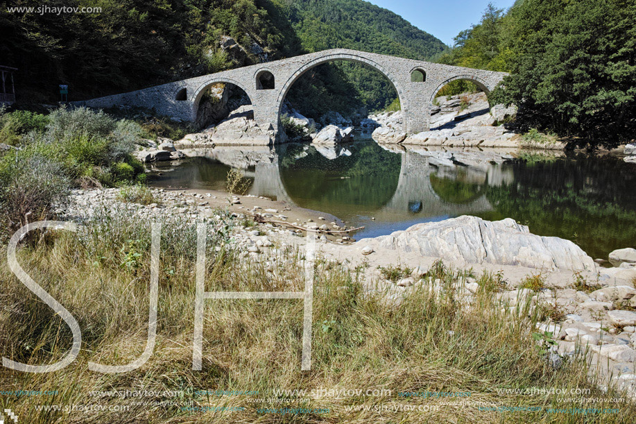 Reflection of Devil"s Bridge and Rhodopes mountain in Arda river, Kardzhali Region, Bulgaria