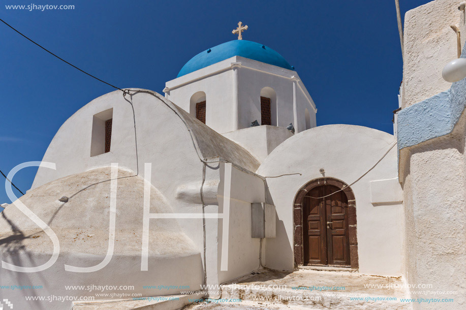 White Orthodox church with blue roof in Santorini island, Thira, Cyclades, Greece