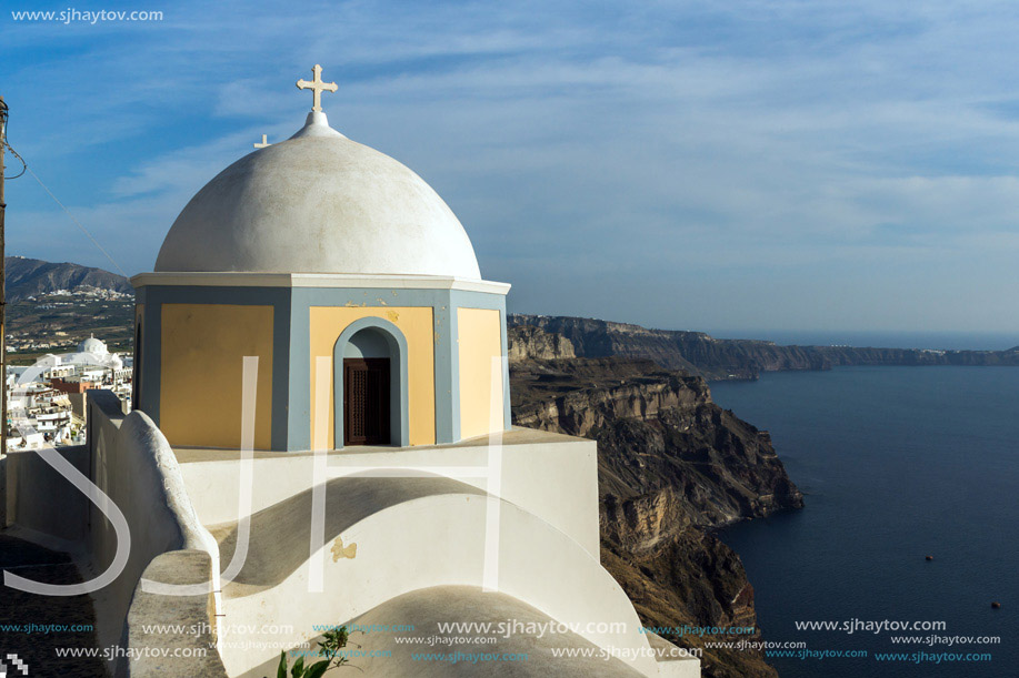 Orthodox church in town of Firostefani and panorama Santorini island, Thira, Cyclades, Greece