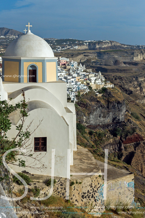 Orthodox church in town of Firostefani and panoramic view of Santorini island, Thira, Cyclades, Greece