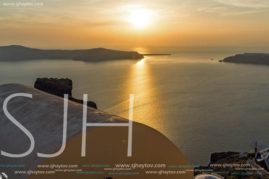 White roof and Amazing sunset in town of Imerovigli, Santorini island, Thira, Cyclades, Greece