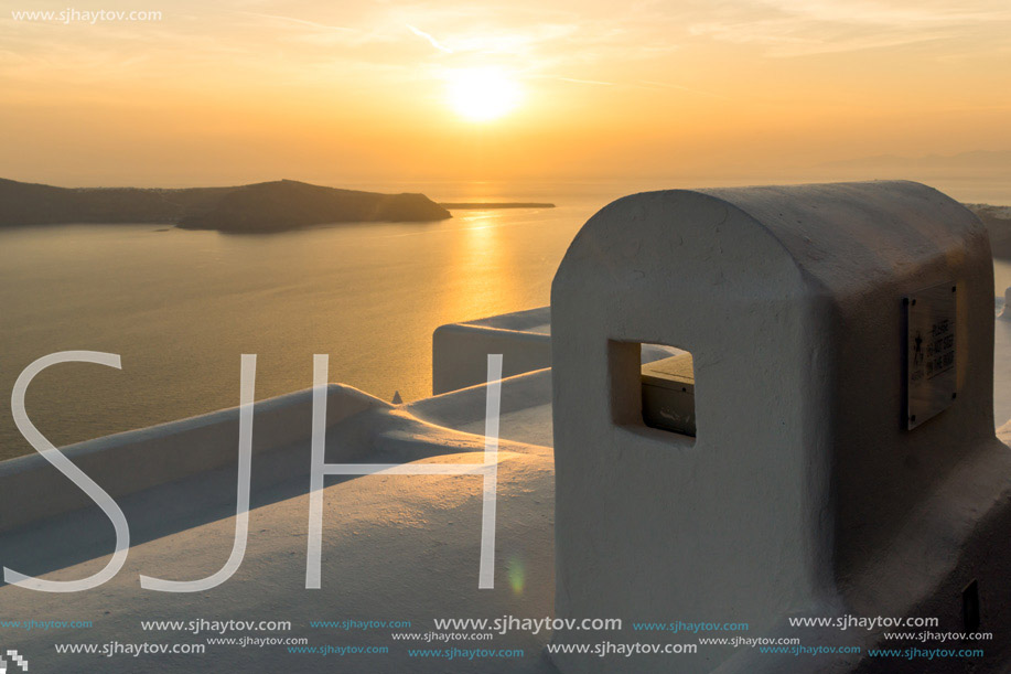 White roof and Amazing sunset in town of Imerovigli, Santorini island, Thira, Cyclades, Greece